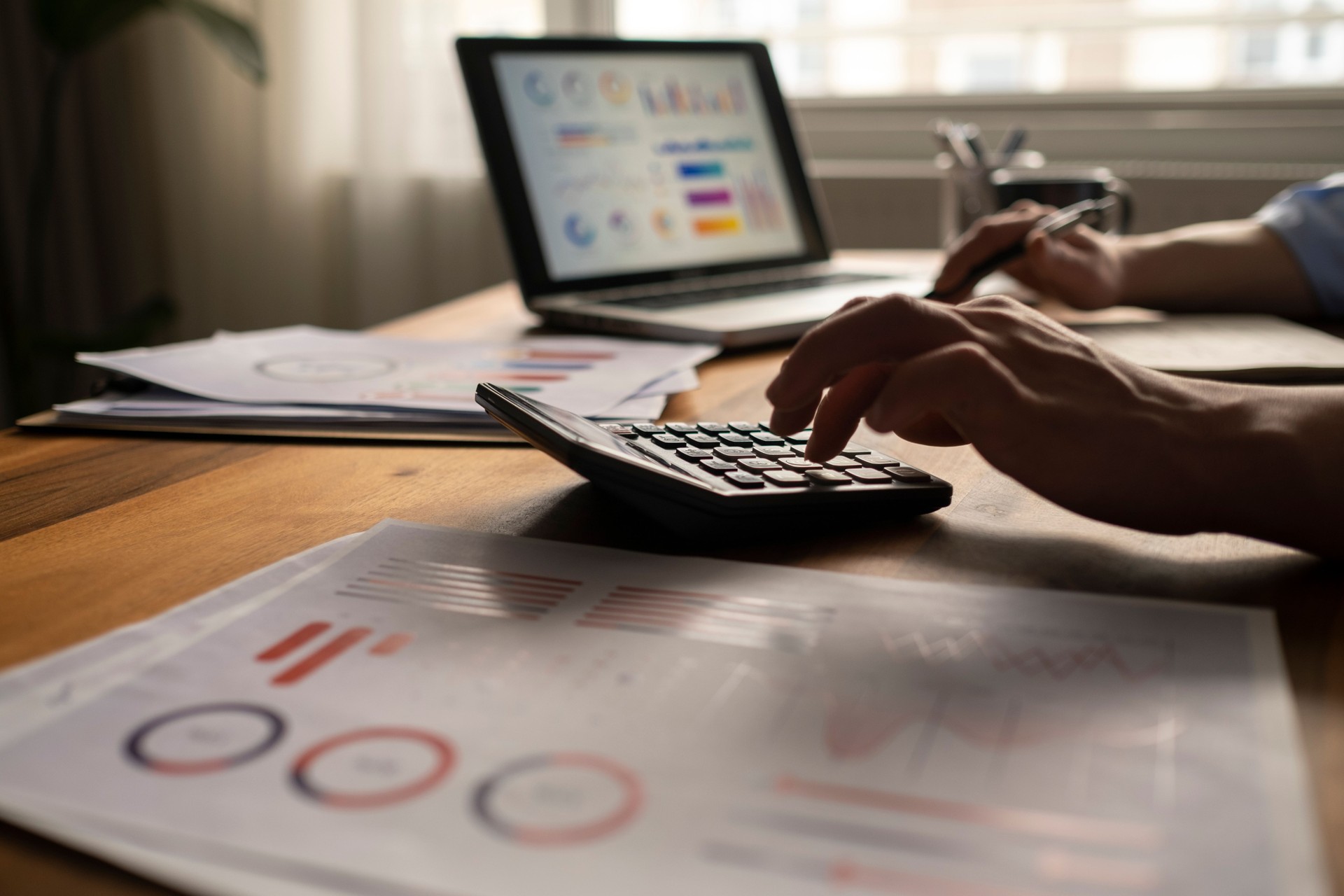 Business accounting concept, Business man using calculator with computer laptop, budget and loan paper in office.